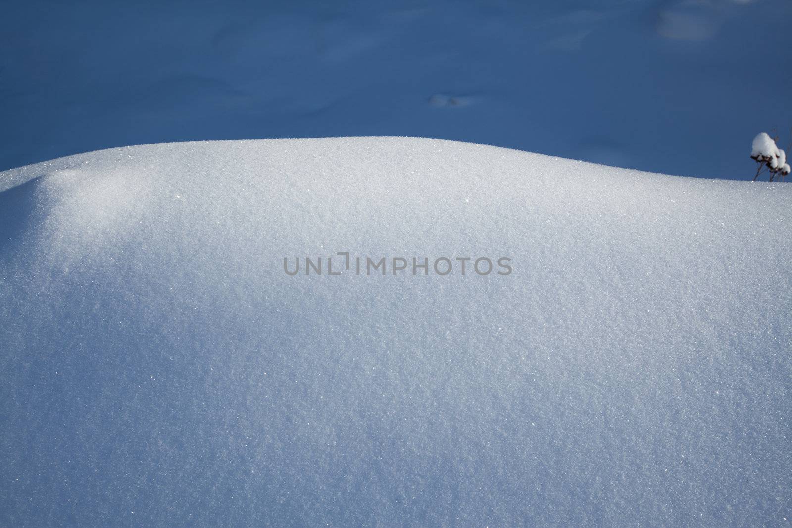 Image of snowbound field divided by shadow and light zones