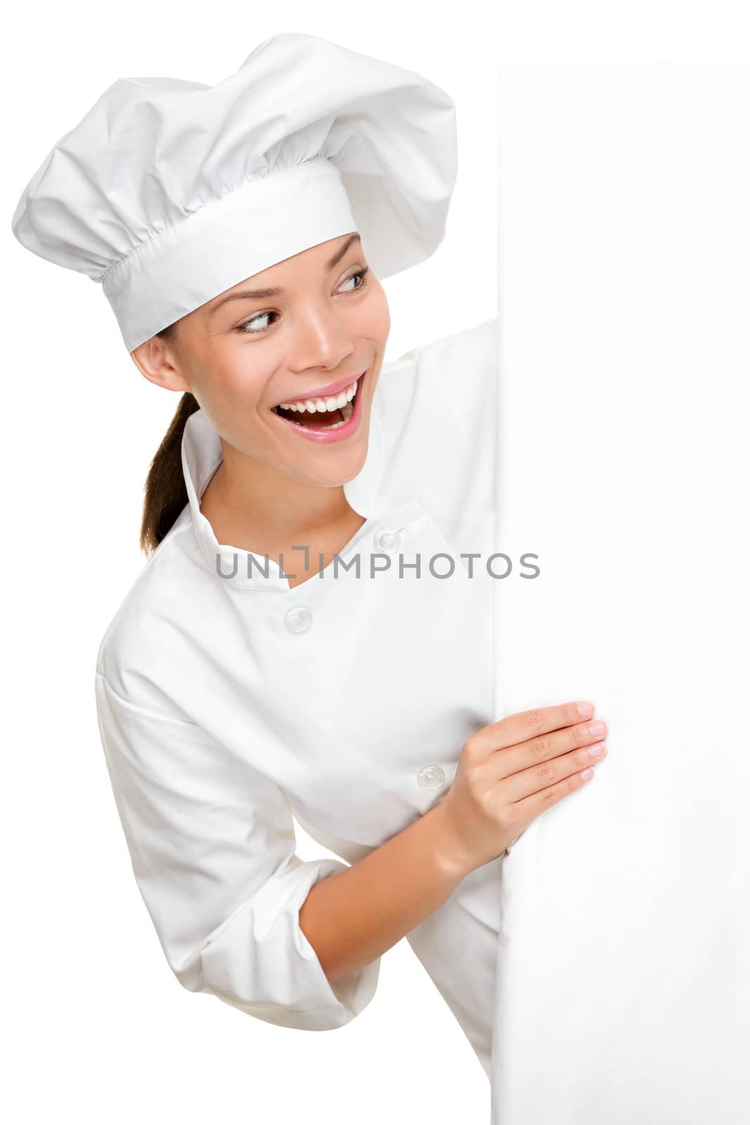 Baker, chef or cook showing sign billboard looking excited happy and smiling. Young female multiracial chef in chefs uniform isolated on white background.