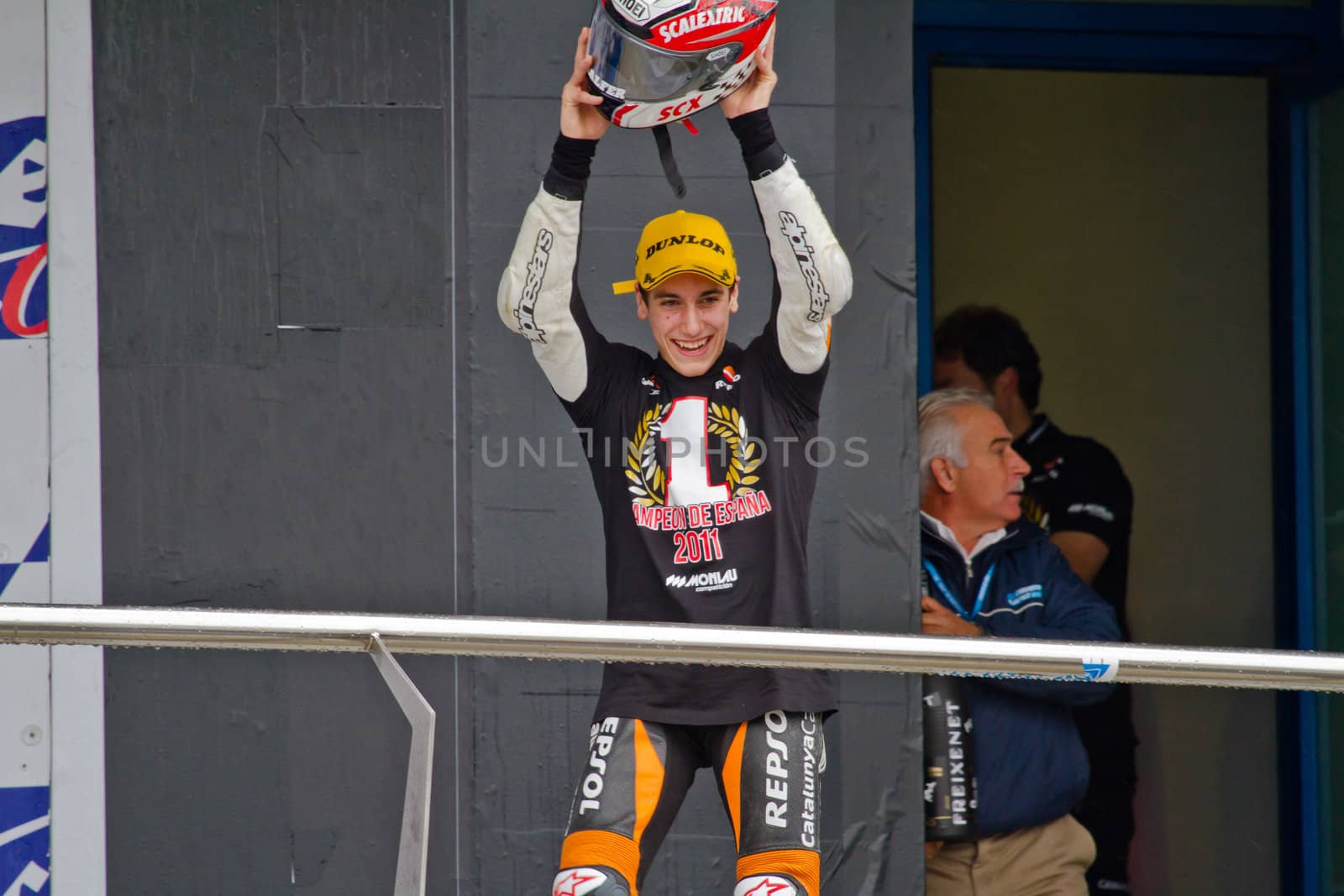JEREZ DE LA FRONTERA, SPAIN - NOV 20: 125cc motorcyclist Alex Rins on the podium like winner of the 125cc CEV Championship on November 20, 2011, in Jerez de la Frontera, Spain