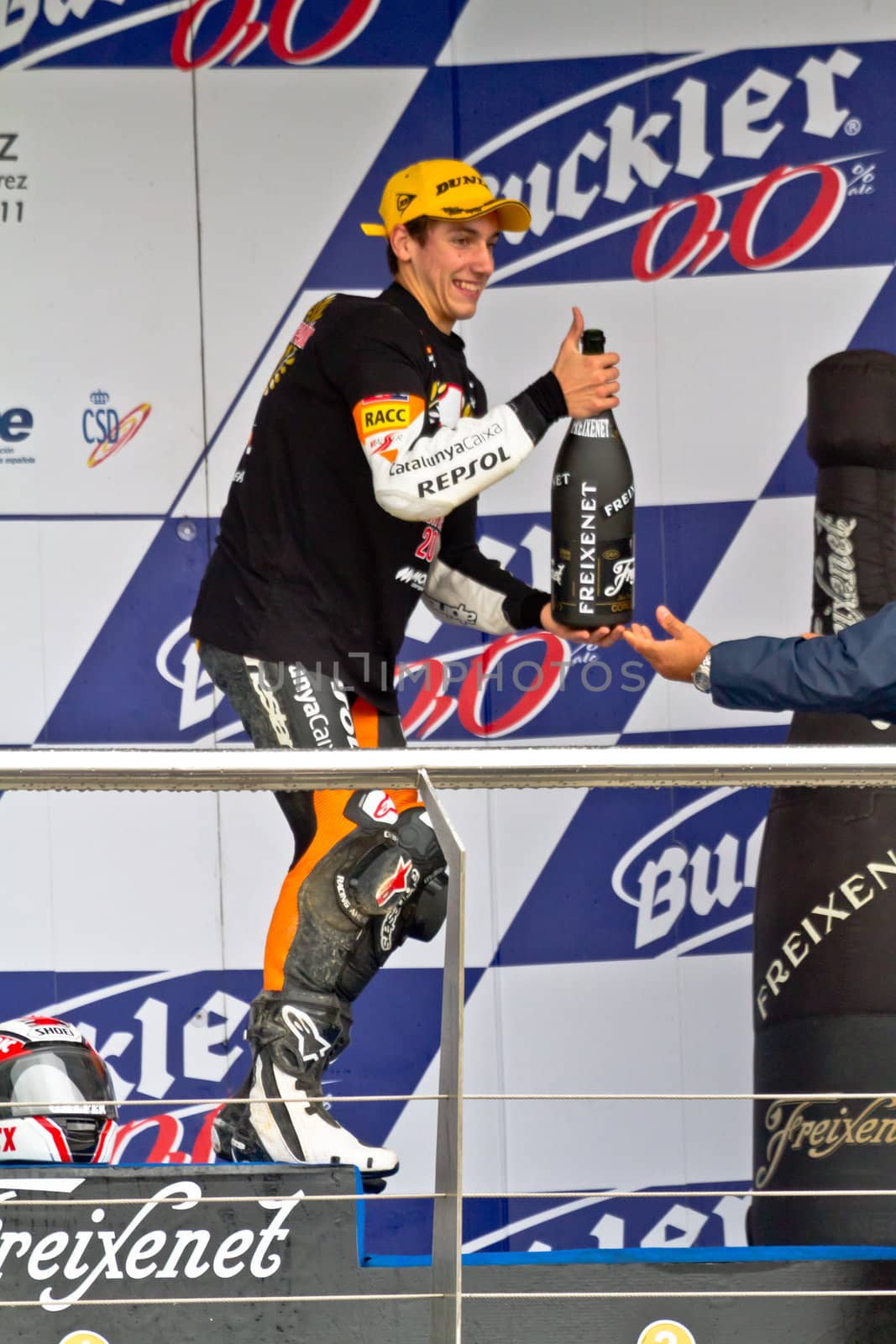 JEREZ DE LA FRONTERA, SPAIN-NOV 20: 125cc motorcyclist Alex Rins on the podium like winner of the 125cc CEV Championship celebrating with champagne on November 20, 2011, in Jerez de la Frontera, Spain