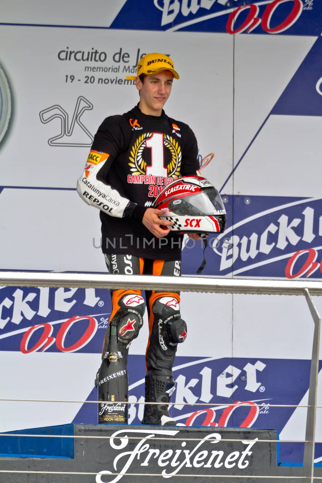 JEREZ DE LA FRONTERA, SPAIN - NOV 20: 125cc motorcyclist Alex Rins on the podium like winner of the 125cc CEV Championship on November 20, 2011, in Jerez de la Frontera, Spain