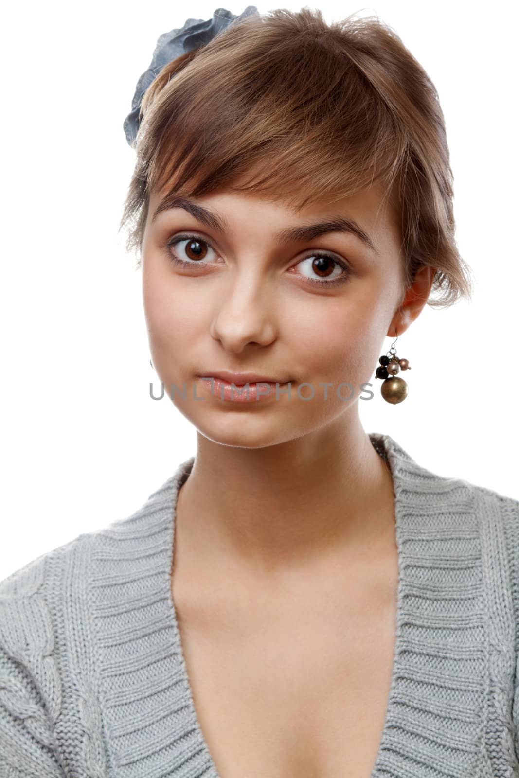 Portrait of the young girl in flower in hair on white background
