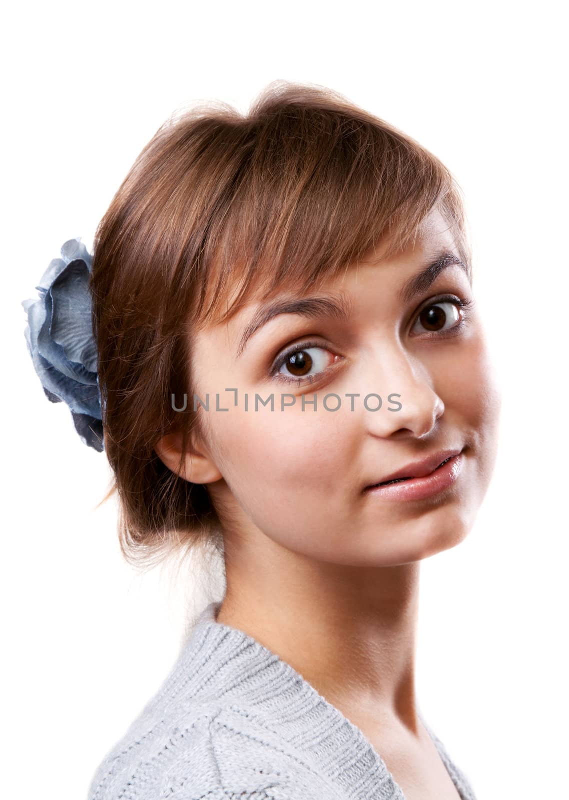 Portrait of the young girl in flower in hair on white background