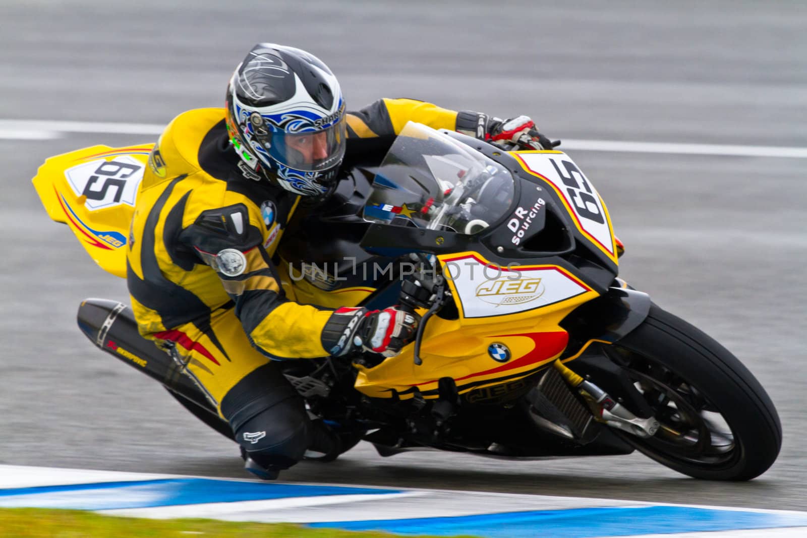 JEREZ DE LA FRONTERA, SPAIN - NOV 20: Stock Extreme motorcyclist Juan Eric Gomez takes a curve in the CEV Championship race on November 20, 2011 in Jerez de la Frontera, Spain
