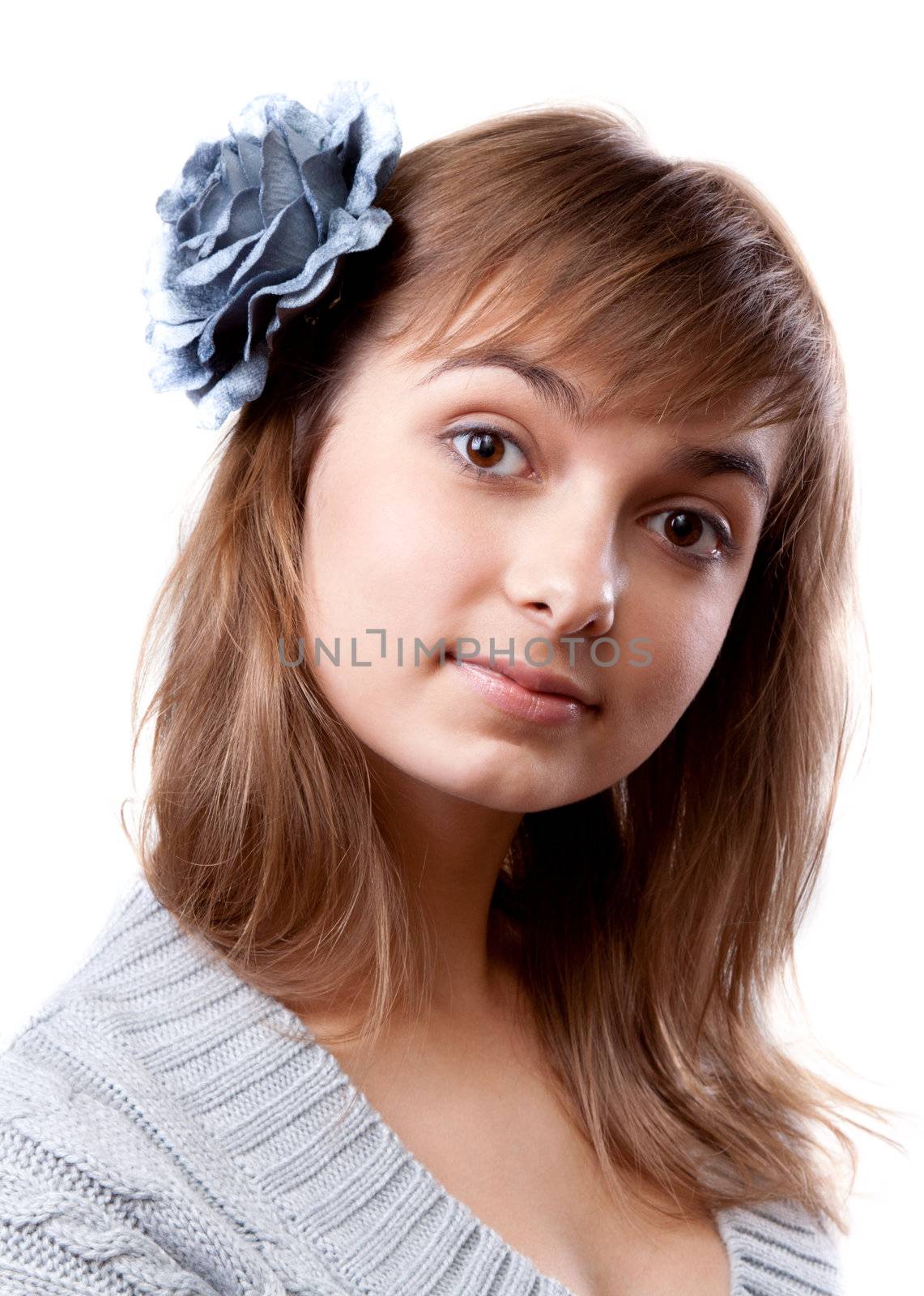 Portrait of the young girl in flower in hair on white background