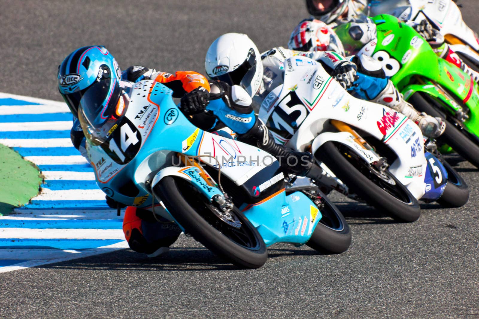 JEREZ DE LA FRONTERA, SPAIN - APR 16: 125cc motorcyclists Kumar(14), Fenati(15) and Guevara(58)takes a curve in the CEV Championship race on April 16, 2011 in Jerez de la Frontera, Spain.
