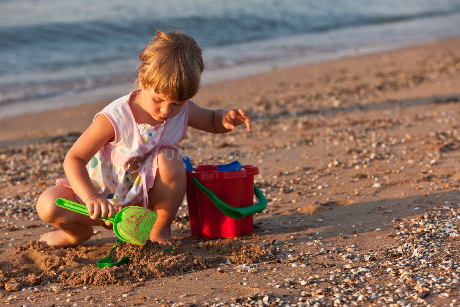 people series: little girl on the beach play with toy