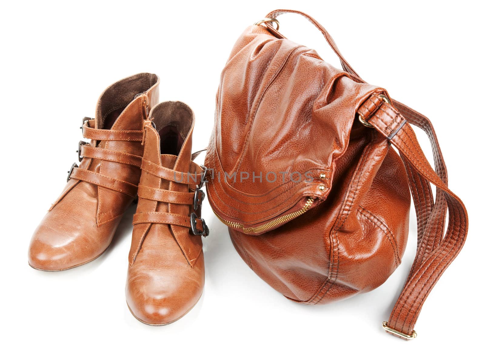 Brown leather bag and pair feminine boots on white background
