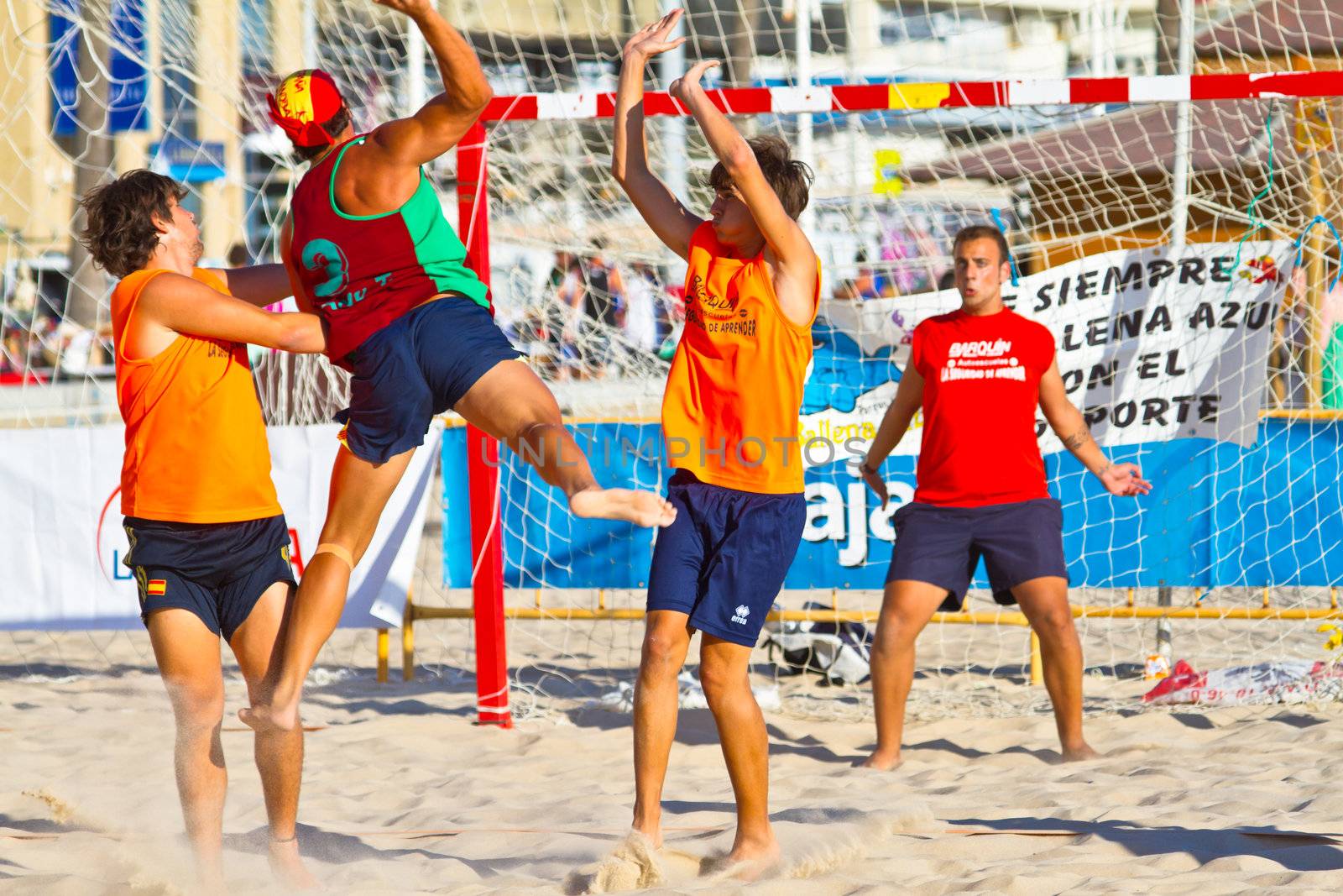 CADIZ, SPAIN - JULY 19: Unidentified players compete in a match between Los Negritos and Autoescuela Barquin in the 19th league of beach handball of Cadiz on July 19, 2011 in Cadiz, Spain