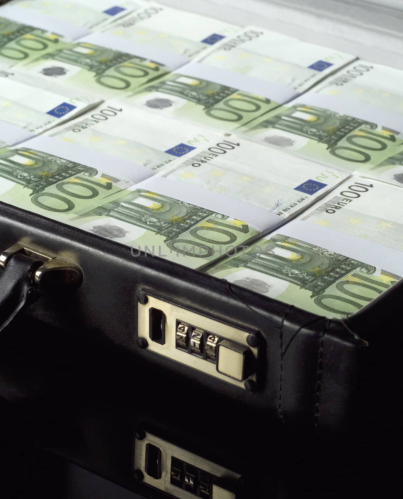 Briefcase with money isolated on black background