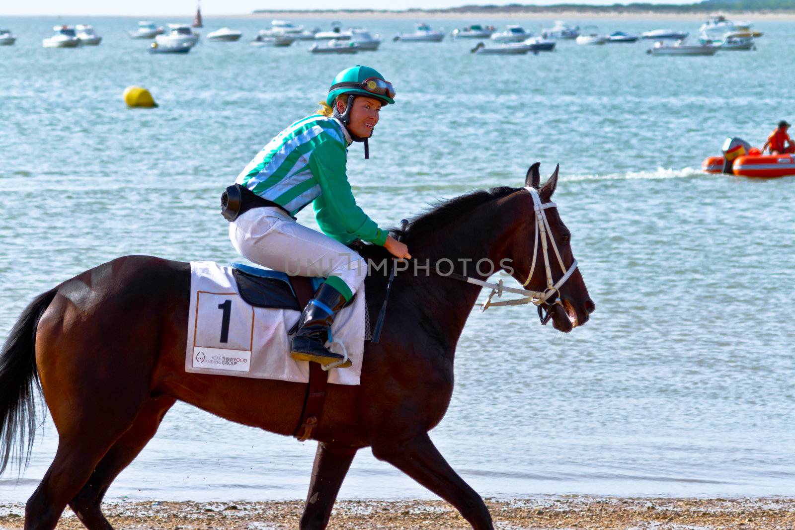SANLUCAR DE BARRAMEDA, CADIZ, SPAIN - AUGUST 10: Unidentified rider at the start of race horses on Sanlucar de Barrameda beach on August 10, 2011 in Sanlucar de Barrameda, Cadiz, Spain.