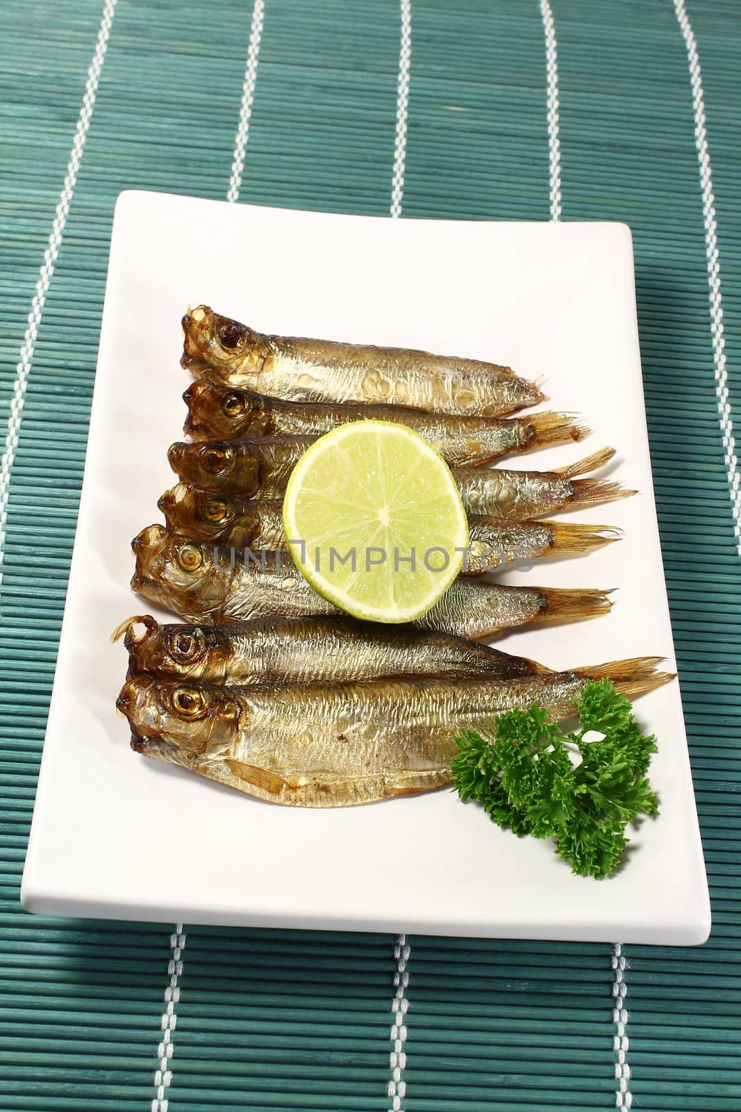 a handful of smoked sprats with lemon and parsley