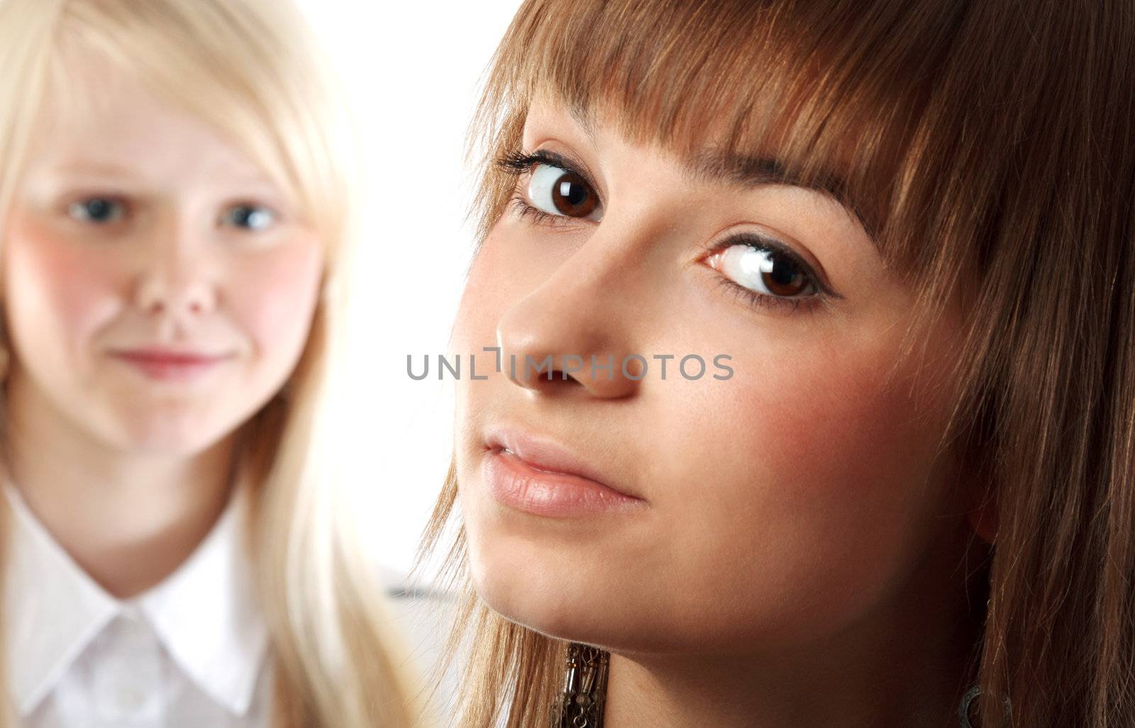 Portrait two girls small depth to sharpnesses on white background