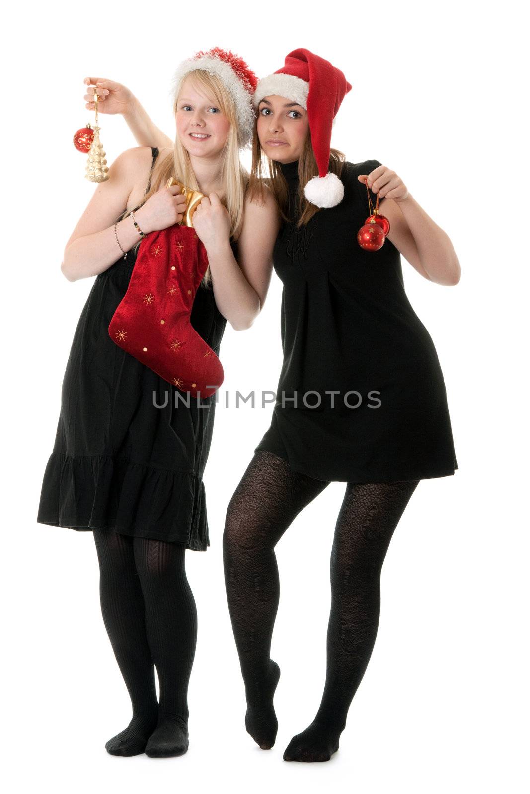 Two girls in the Santa hat and gifts on white background