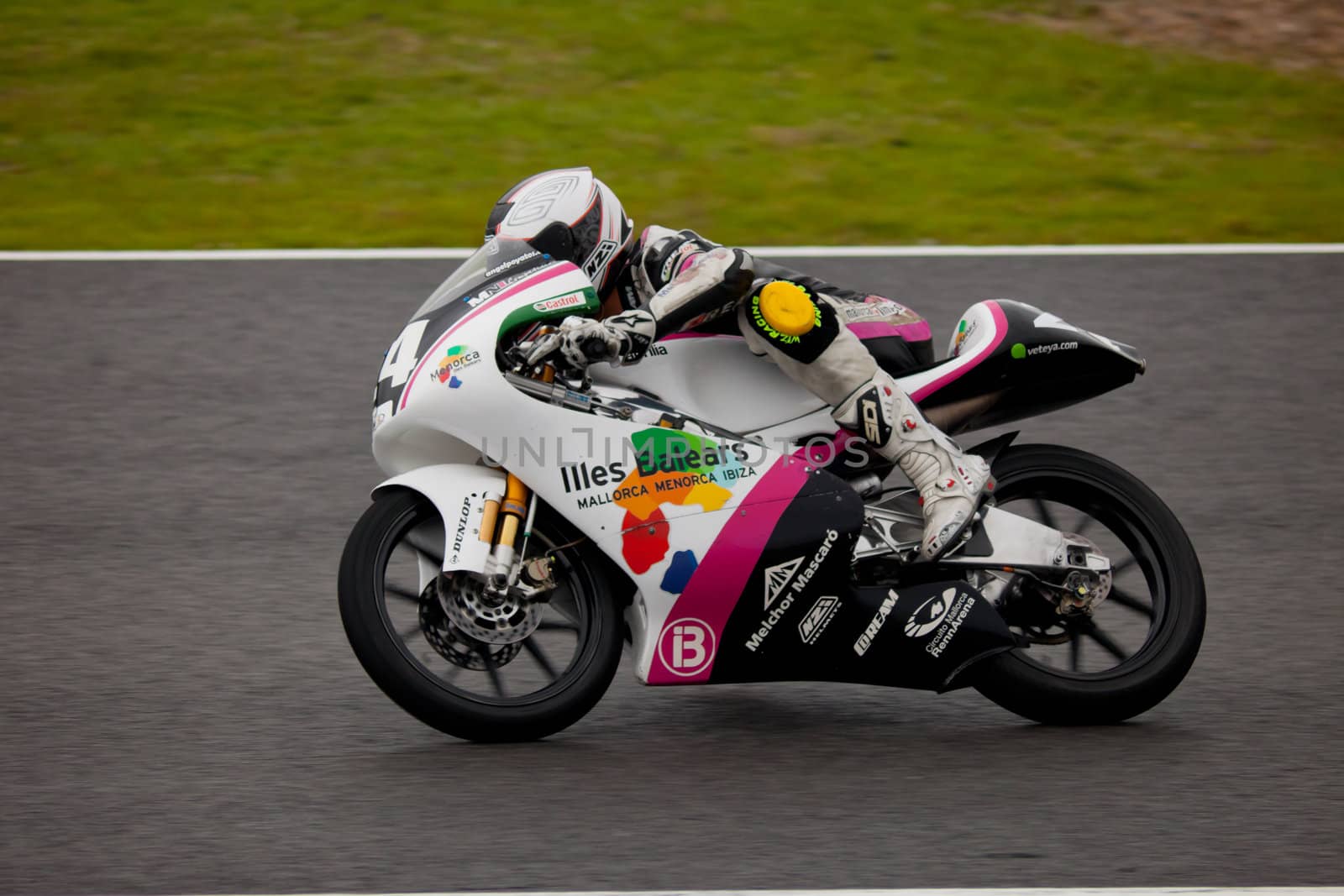 JEREZ DE LA FRONTERA, SPAIN - NOV 20: 125cc motorcyclist Miguel Poyatos Alarcon races in the CEV championship on Nov 20, 2010, in Jerez de la Frontera, Spain