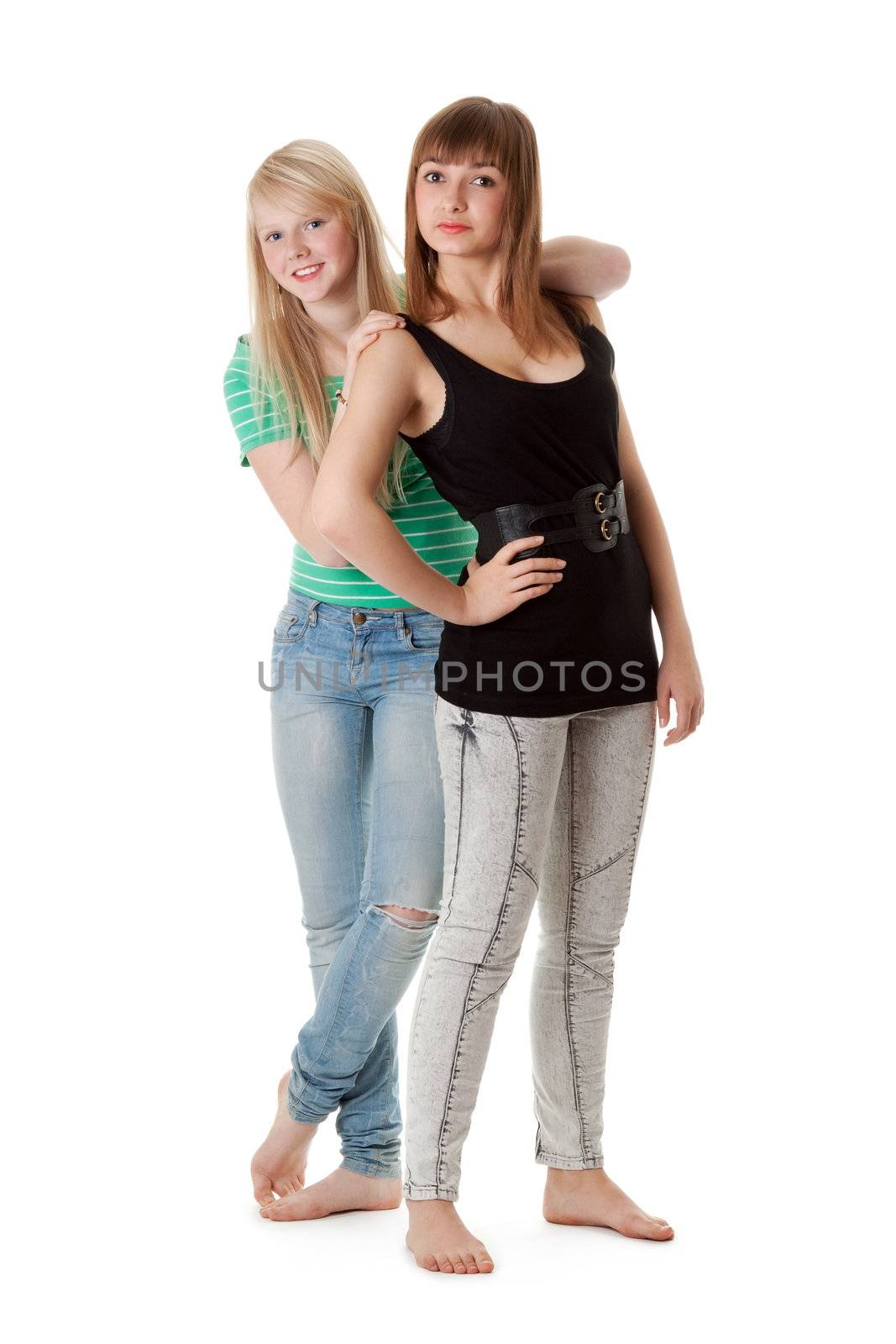 Two girls in jeans on a white background