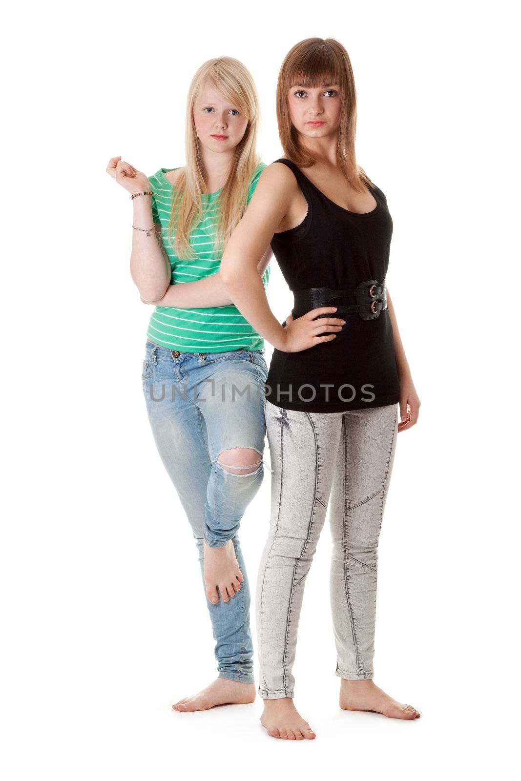 Two girls in jeans on a white background