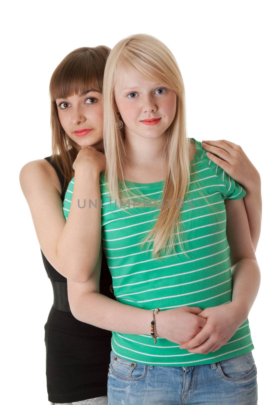 Two girls in jeans on a white background
