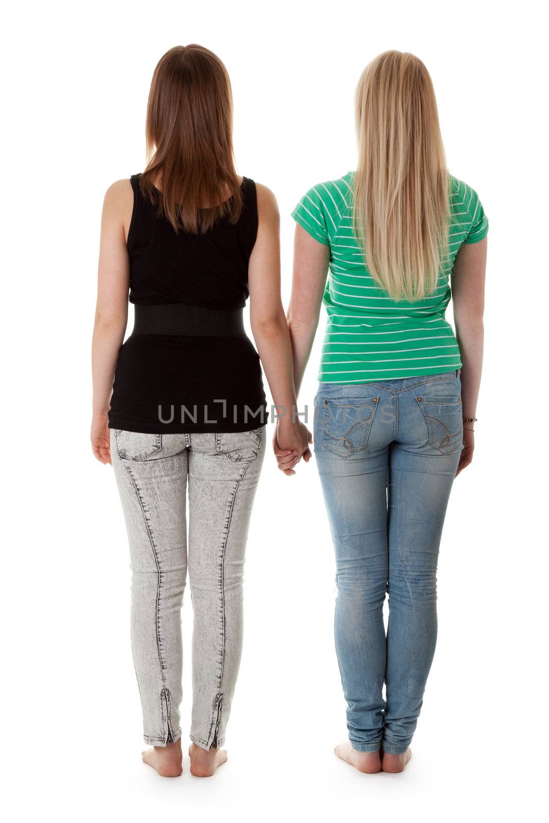 Two girls in jeans are back on a white background
