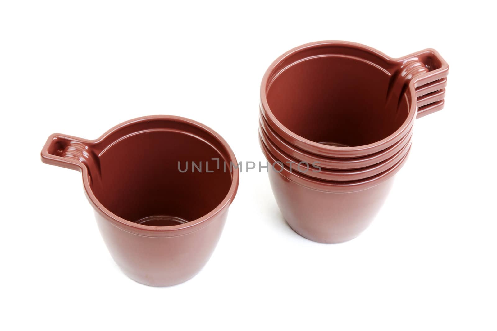 Five brown plastic cups on white background