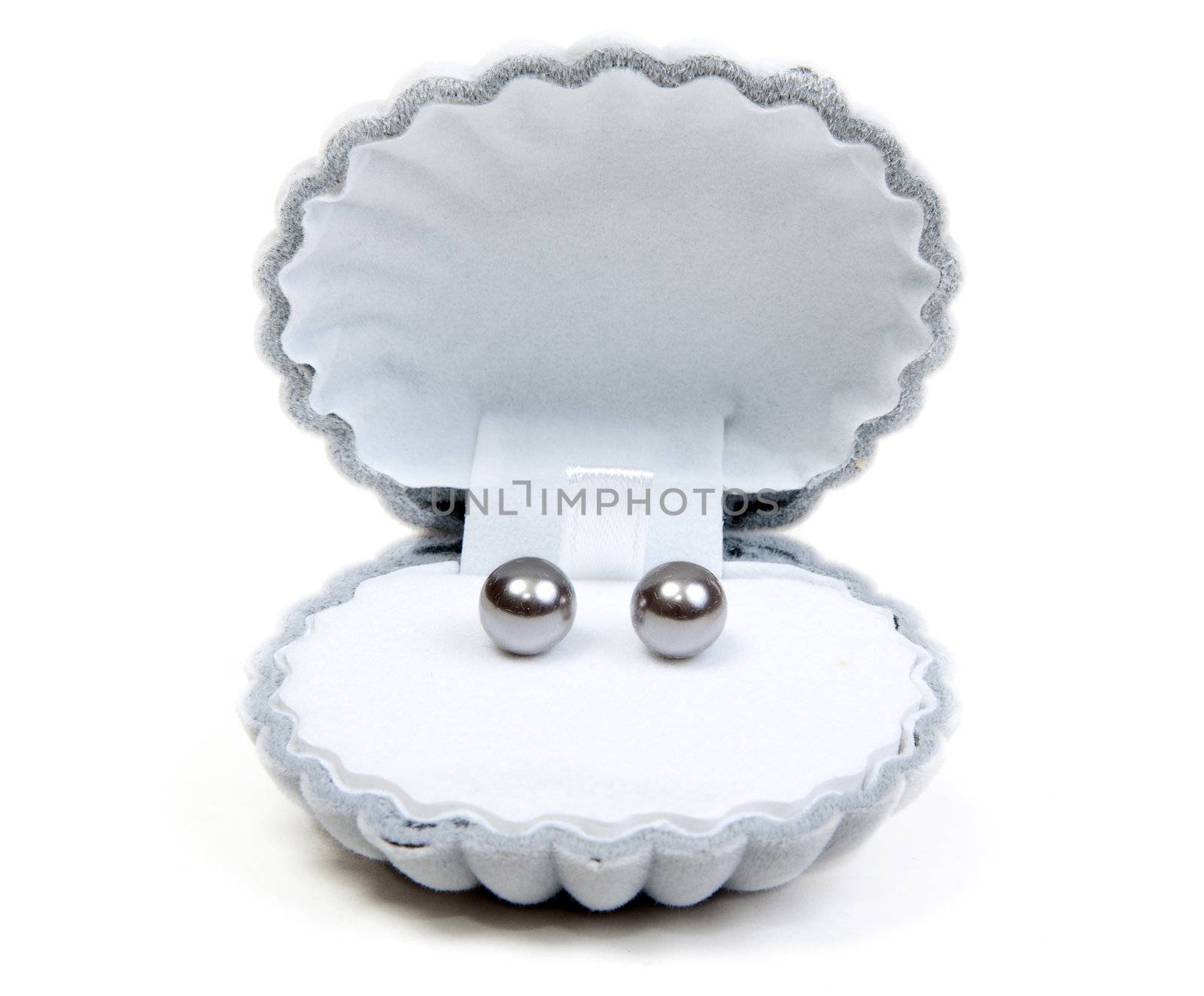 Earrings in small box and necklace on white background