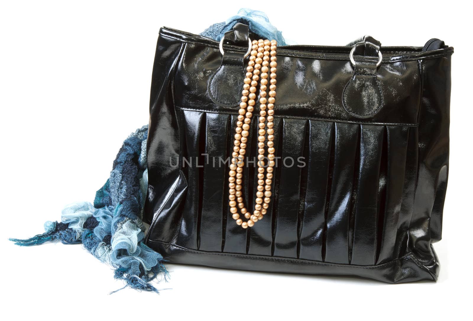 Feminine bag with scarf and necklace on white background