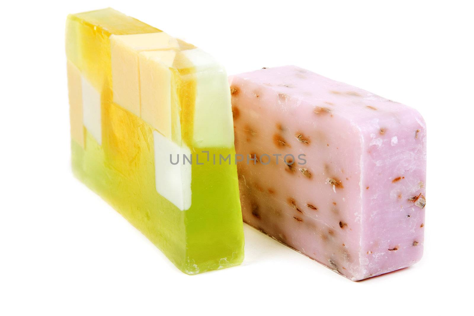 Green and purple fruit soap isolated on white background