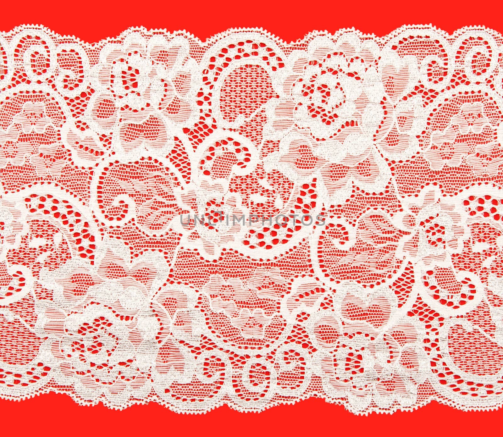 White lace with a floral pattern on a red background