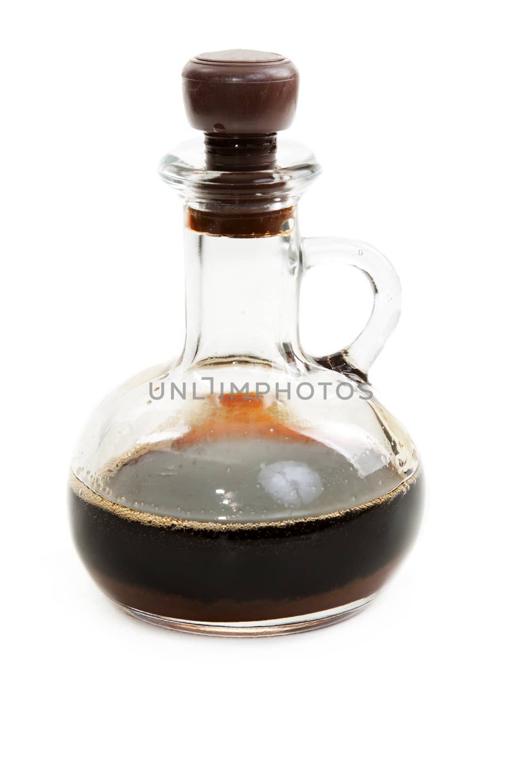 Glass bottle with soy sauce on white background