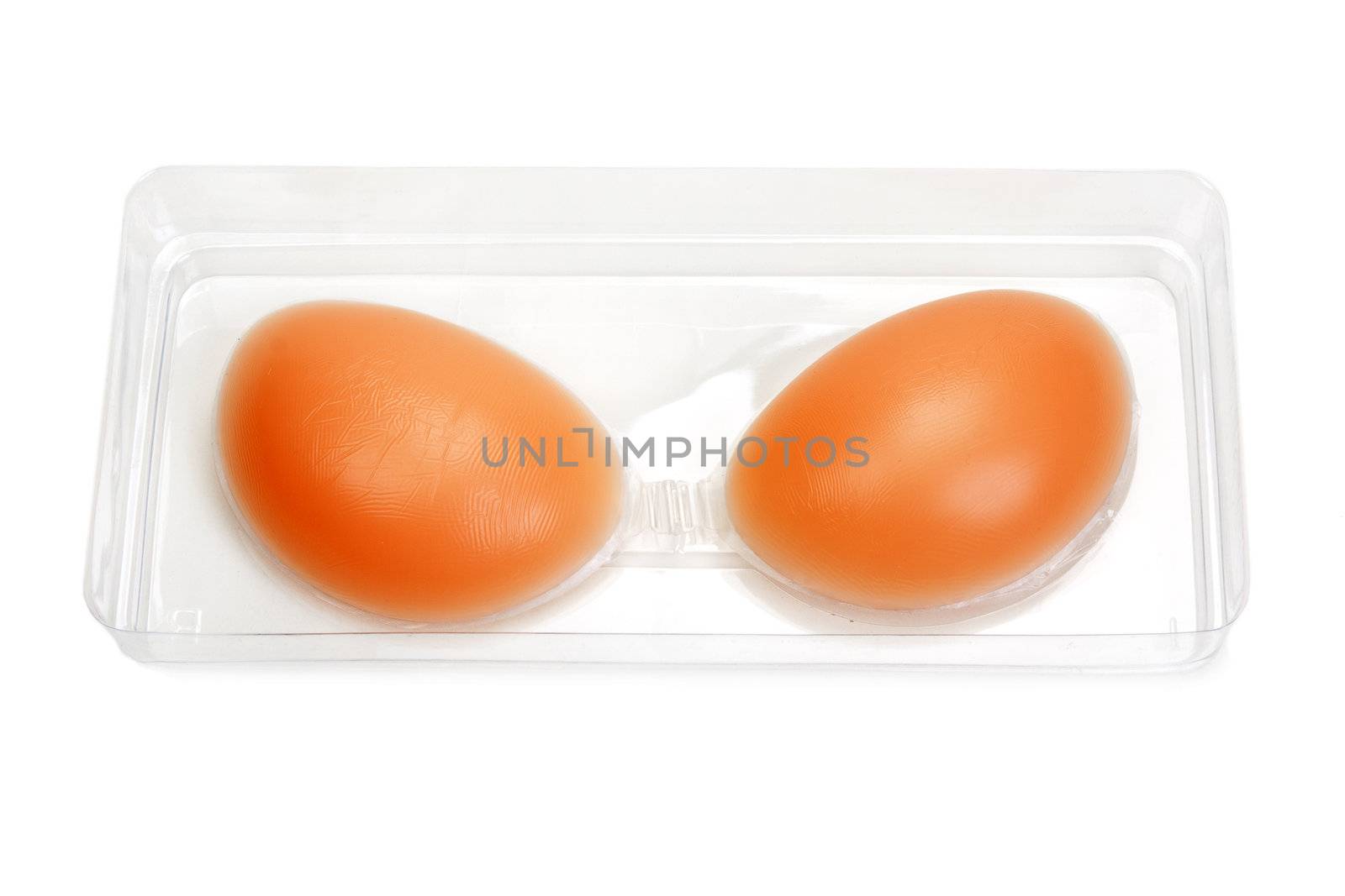 Silicone bra in a transparent box on white background