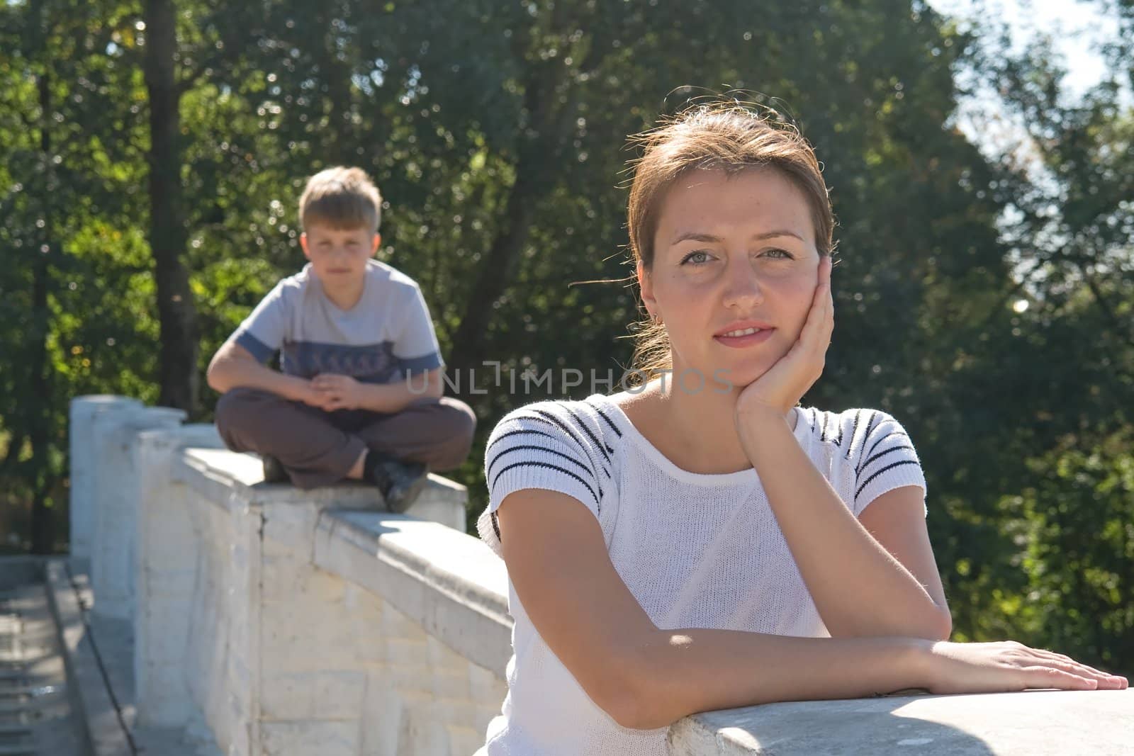 portrait of a beautiful woman. boy at background
