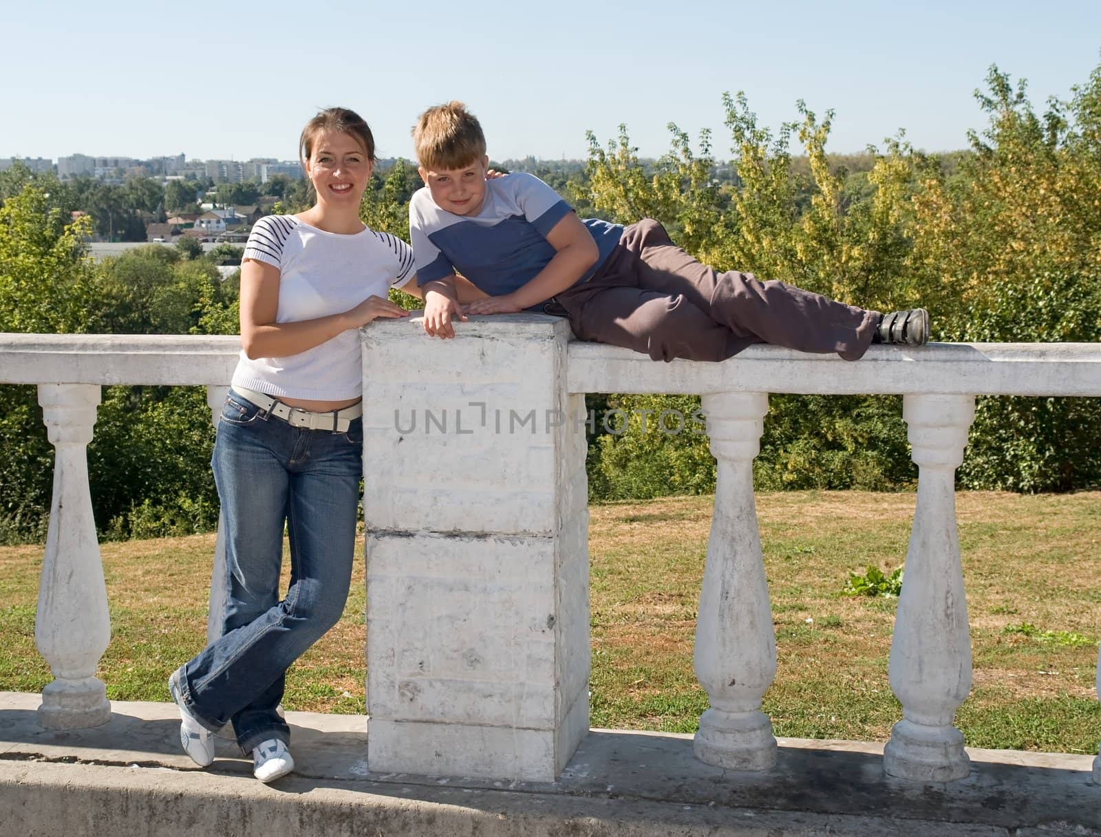 Perpendicular position. Mum and the son in summer park.