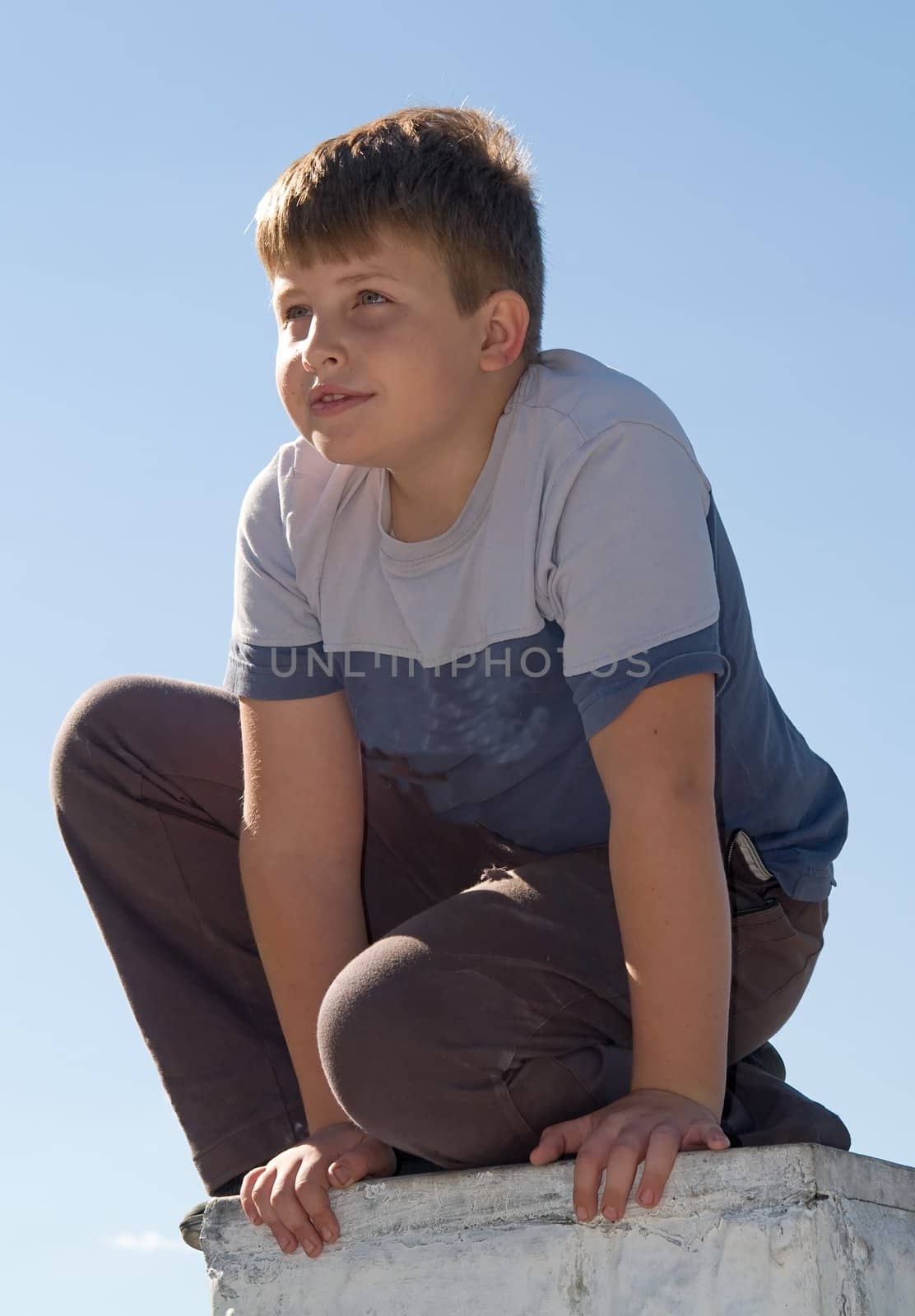 little boy with blue sky at background