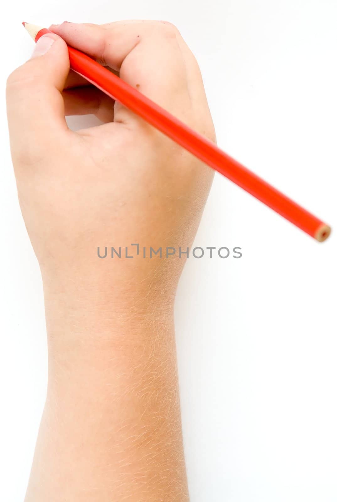 Children's hand with a pencil on a white background