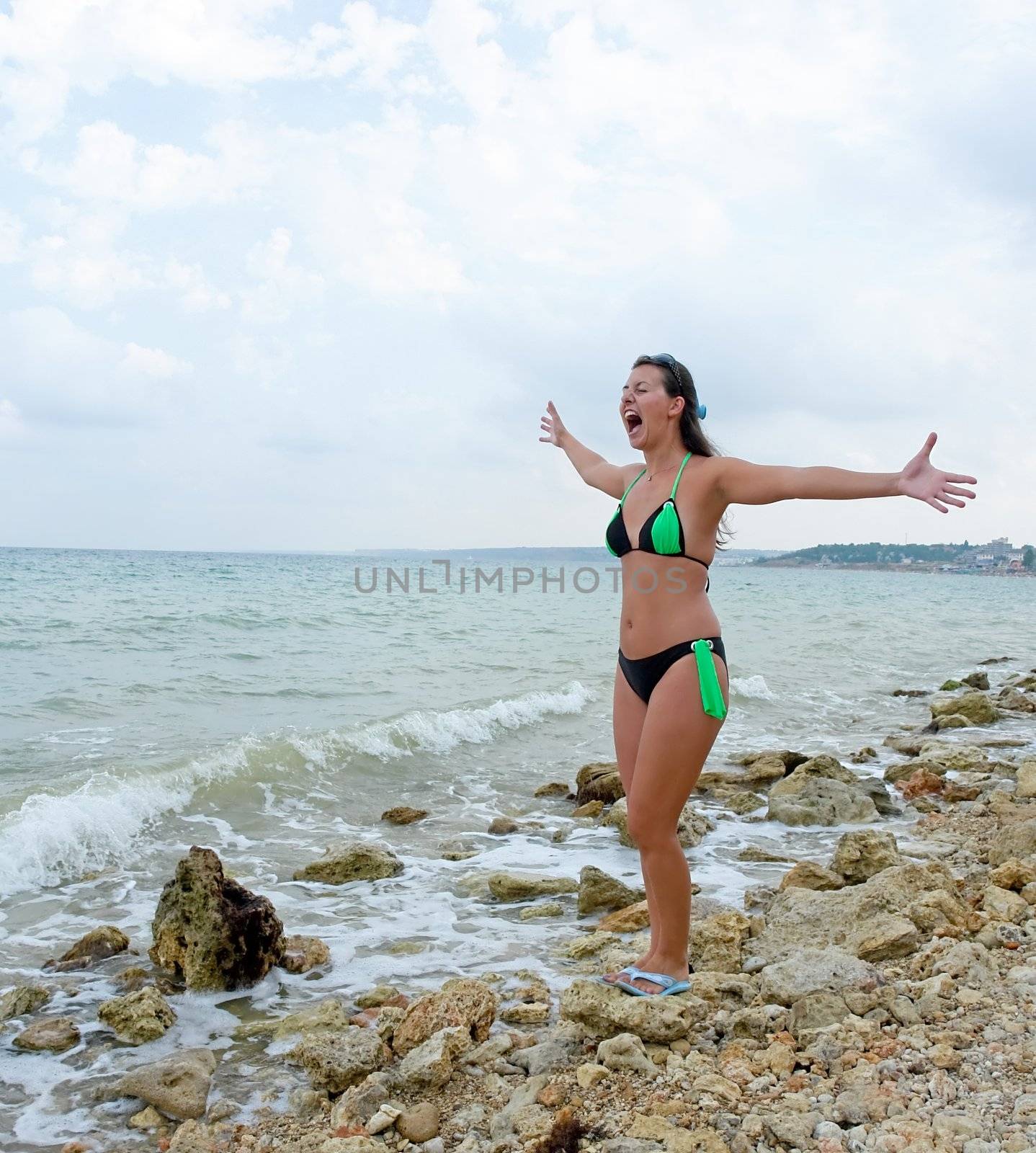 scream. beautiful shouting girl on the beach