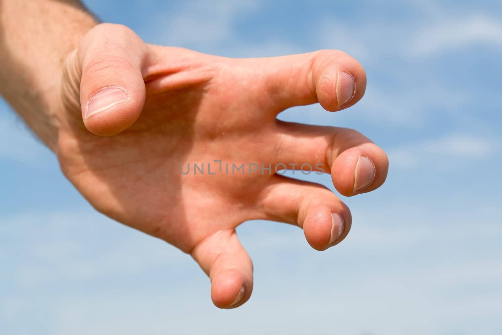Human hand on a blue sky