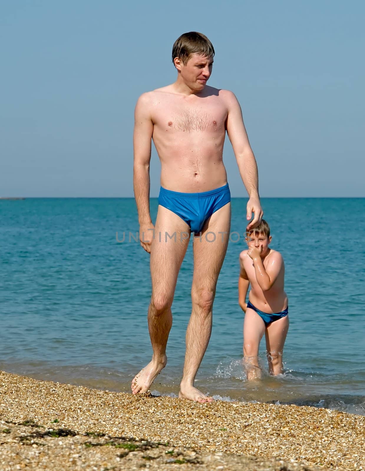 summer days. father and the son on the beach.