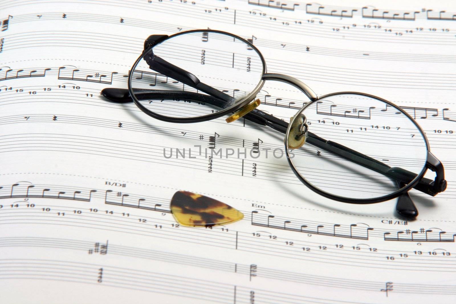 education concepts study music spectacles on a music book and guitar pick
