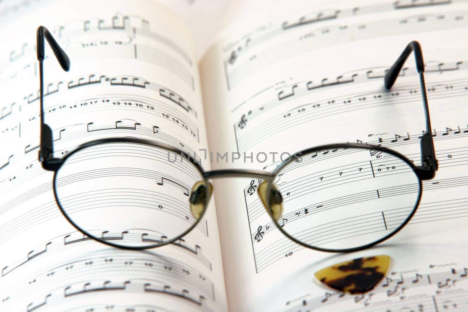 education concepts study music spectacles on a music book and guitar pick