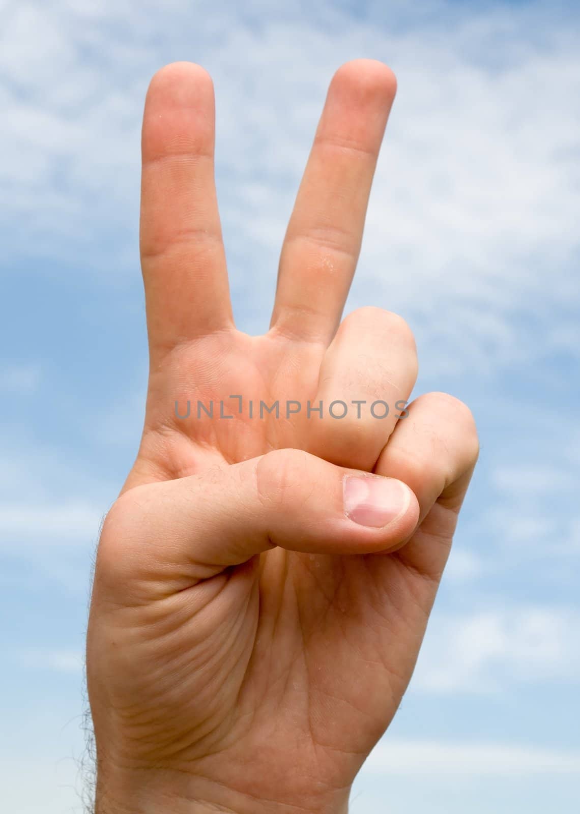 Two. Human hand on a blue sky
