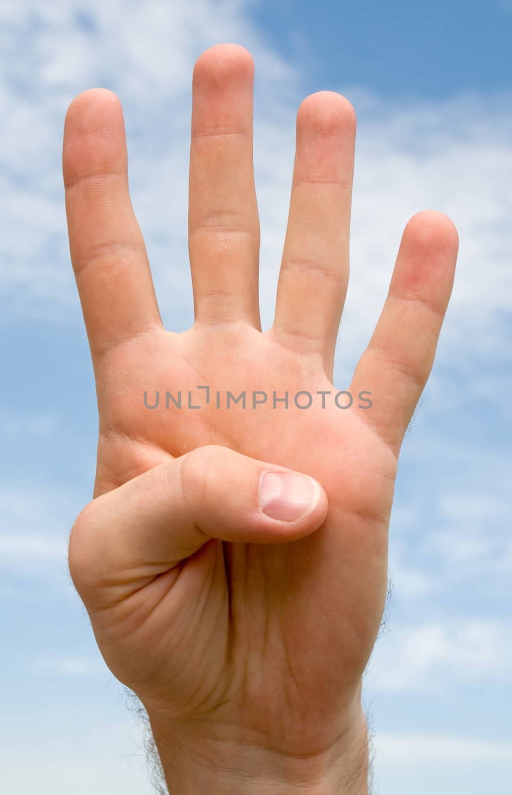 Four. Human hand on a blue sky