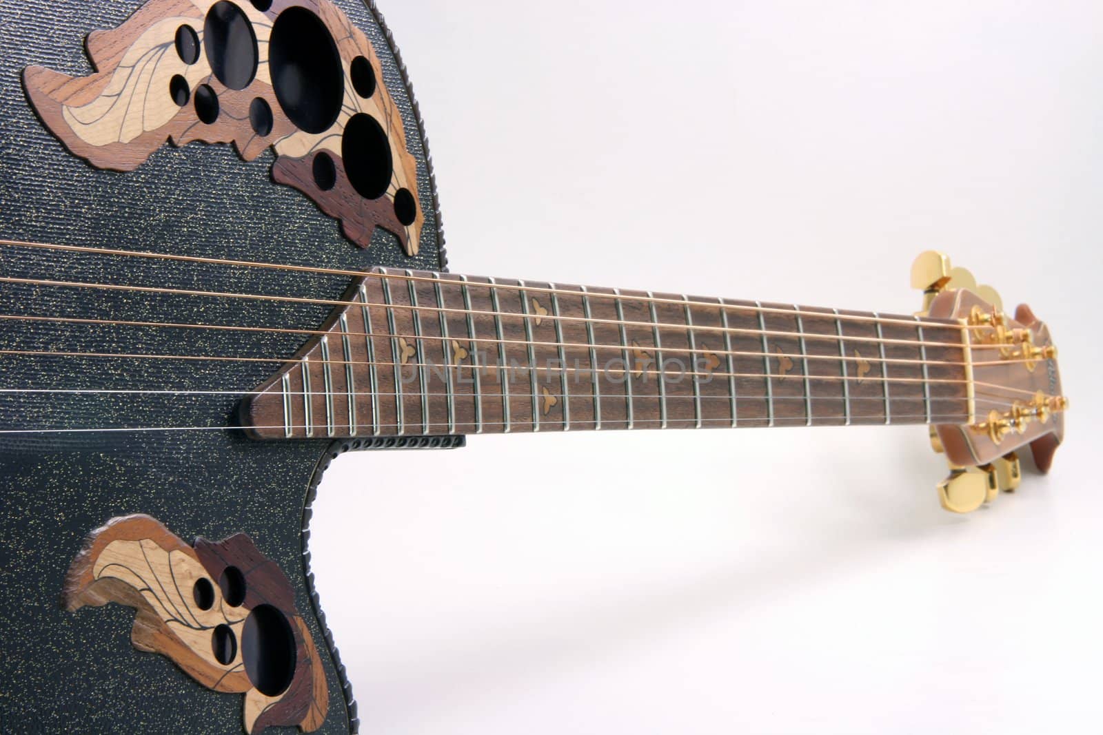 perspective view of black guitar and strings music equipment on white background
