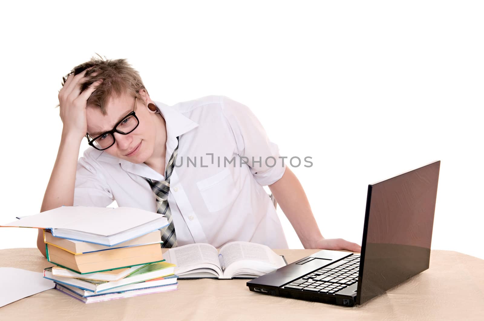 frustrated student sits behind a desk isolated on white background