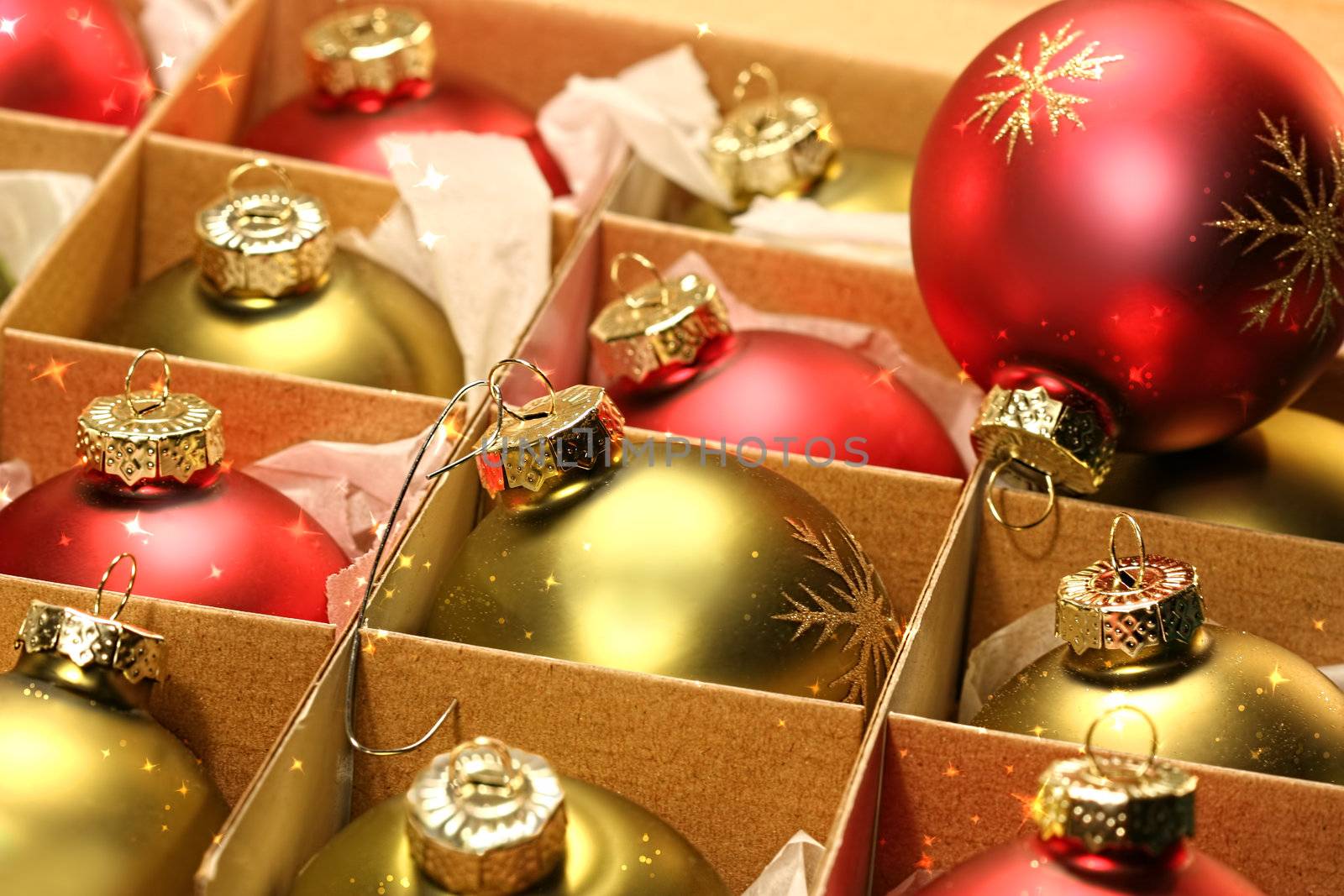 Red and green Christmas balls in box with paper wrapping