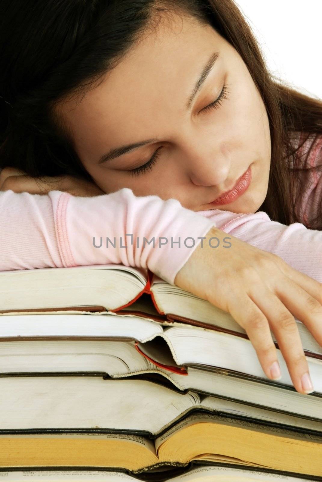 Tired girl sleeping on books stack by simply