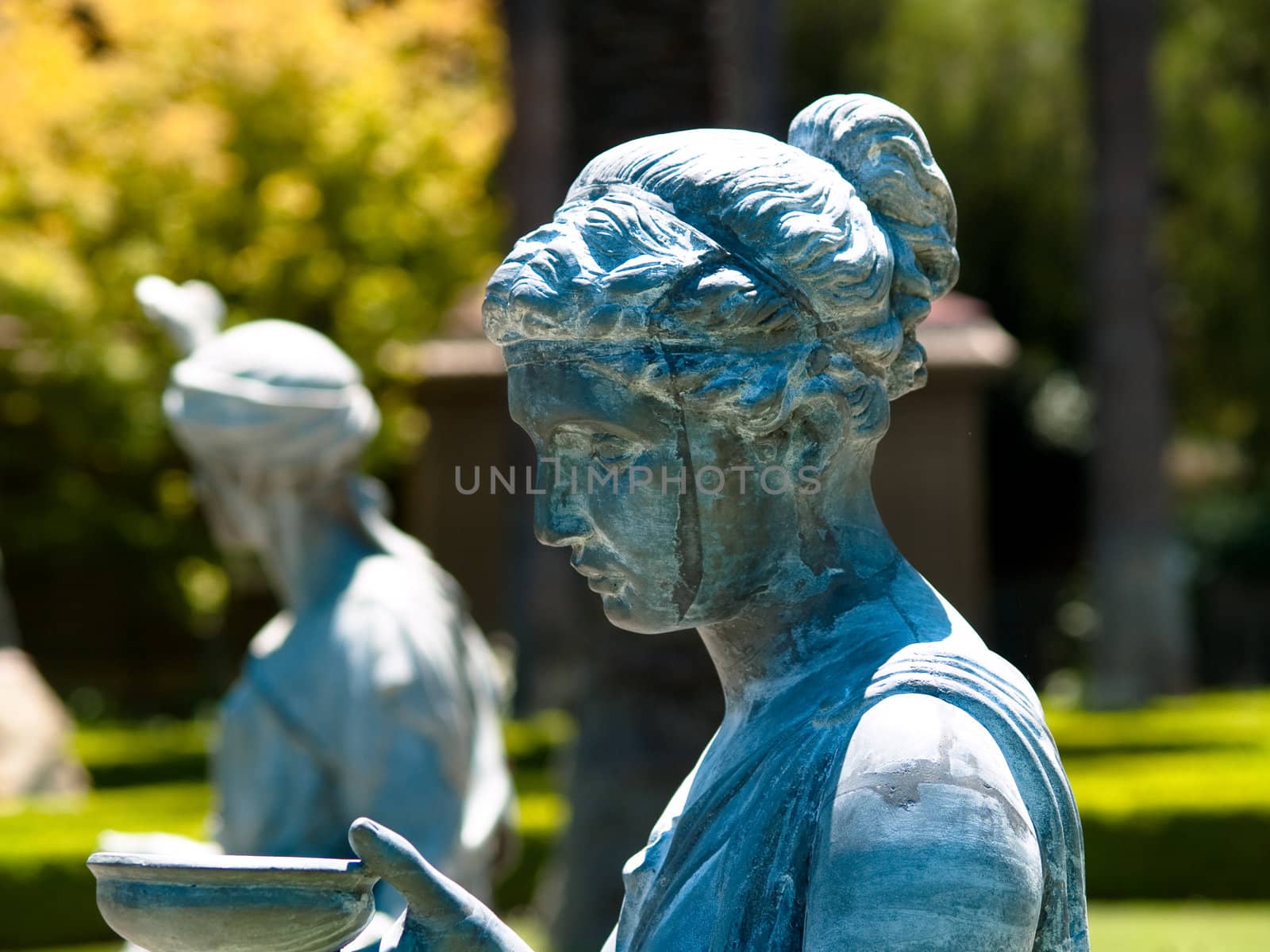 Bronze statues in a garden, both woman and man