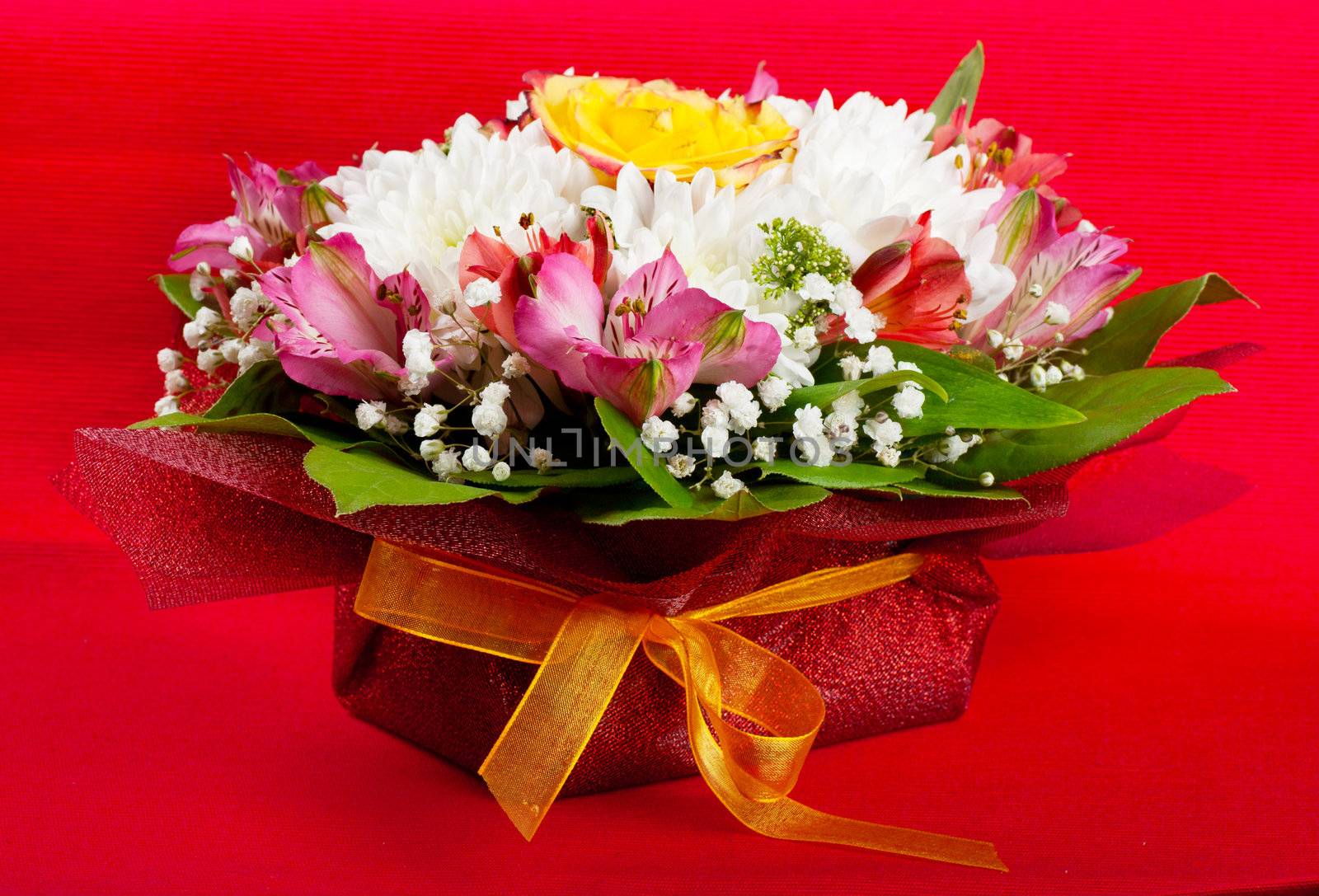 Closeup view of wedding bouquet over red background
