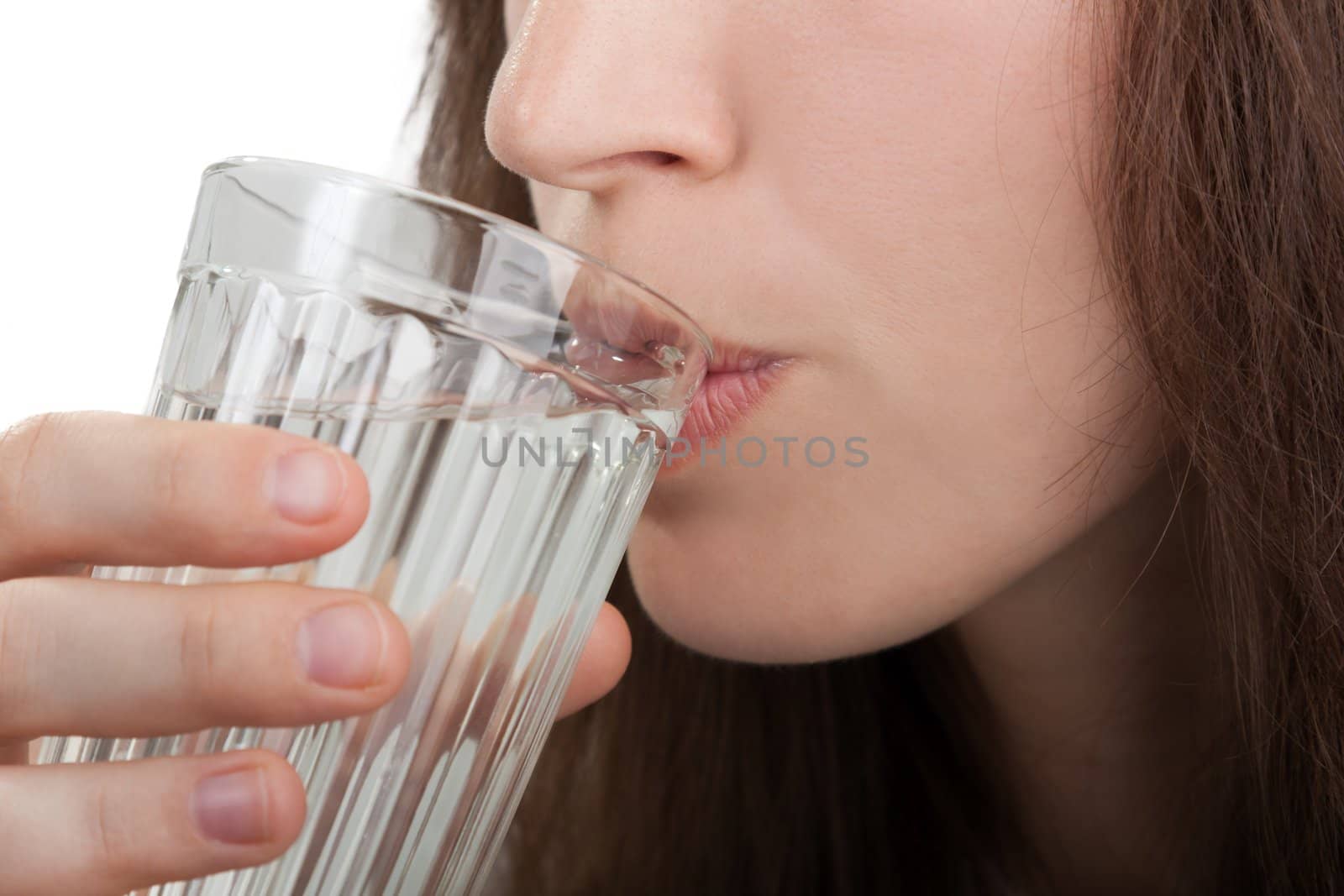 Female human hand holding liquid drink water glass