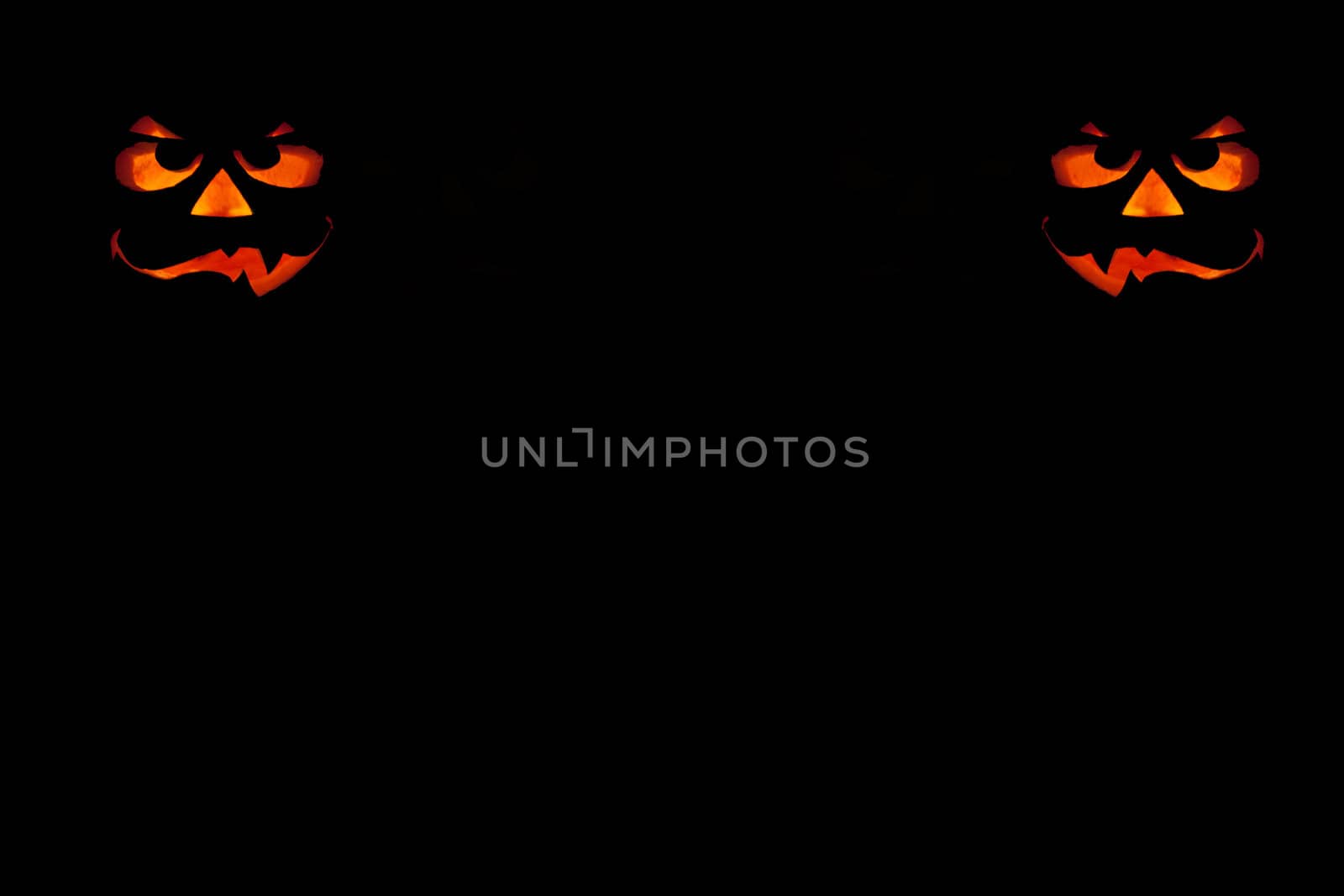 ghastly halloween pumpkin on black background