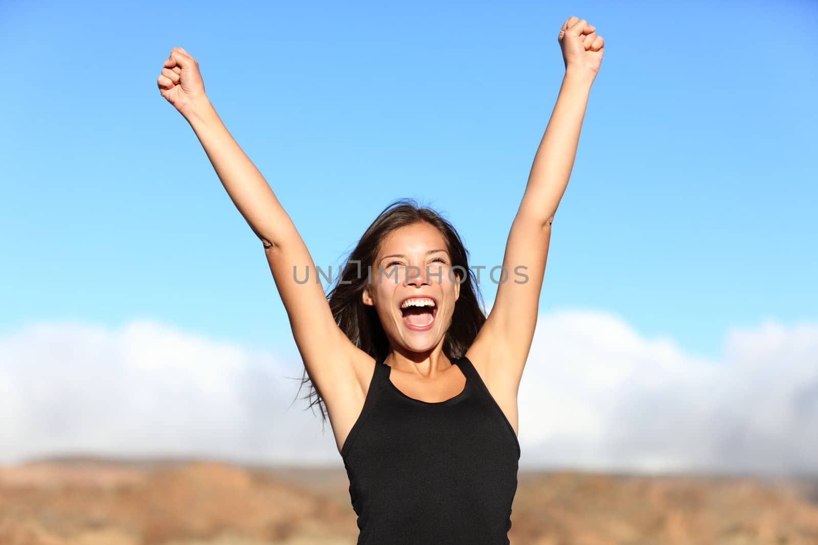 Hiker cheering. Woman hiking cheerful with arms stretched screaming of joy on top of mountain. Beautiful sporty mixed ethnicity woman outdoor.